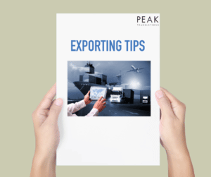 Person holding a paper document with 'exporting tips' stated and image of export transport